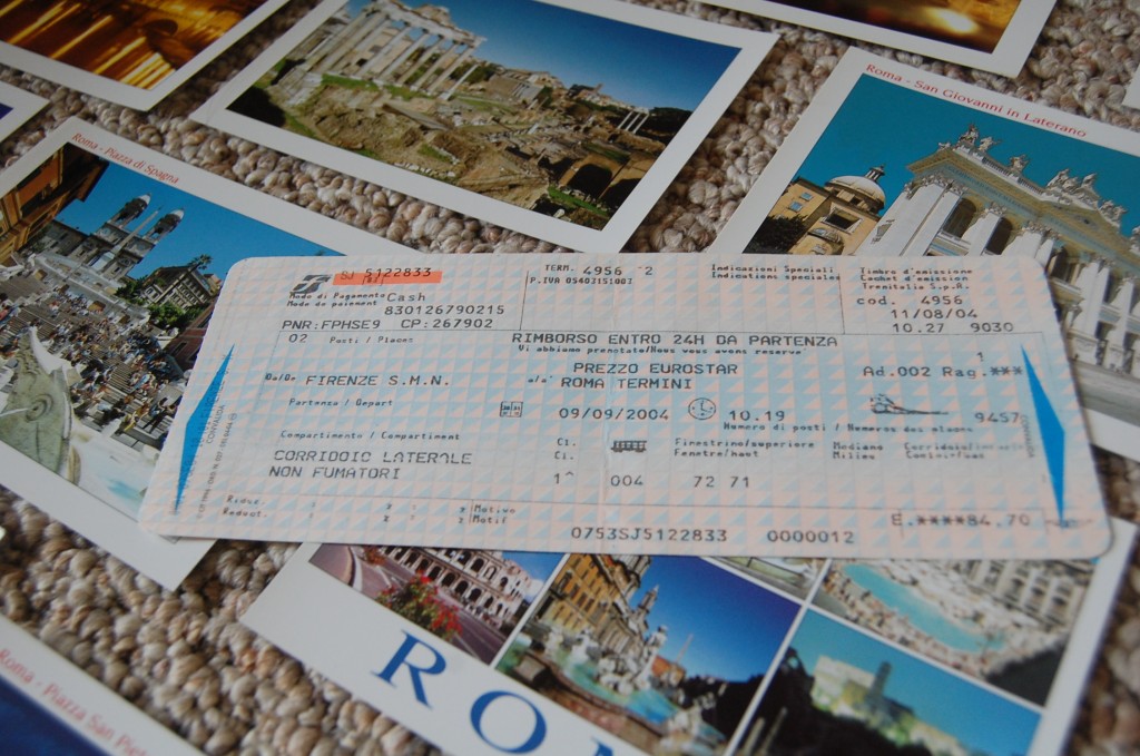 Italian train ticket laying on top of postcards from Rome