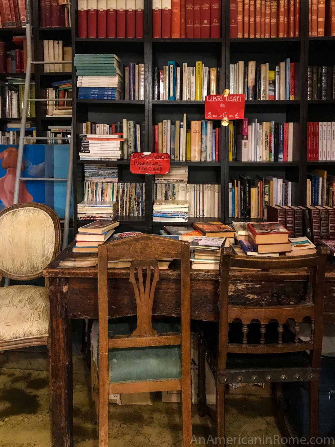 used books on a shelf with antique chairs