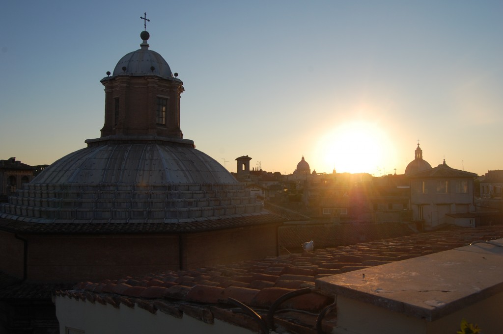 sunset over church domes from the rooftop restaurant at hotel raphael in Rome