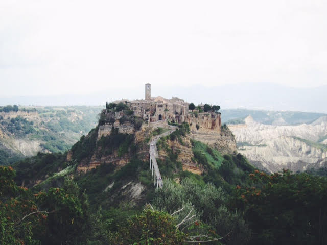 bagnoregio italy stone village on top of a hill with a long bridge leading to it