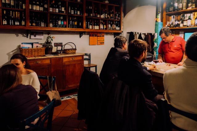 dark interior of wine bar with men at the counter