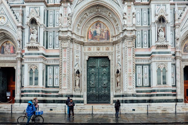 detail of florence duomo facade with doors on a rainy day