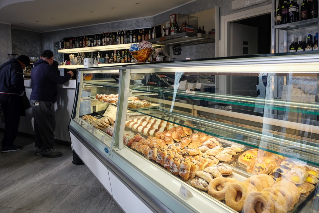 Inside the Il Maritozzaro bar, which has a long glass case filled with pastries