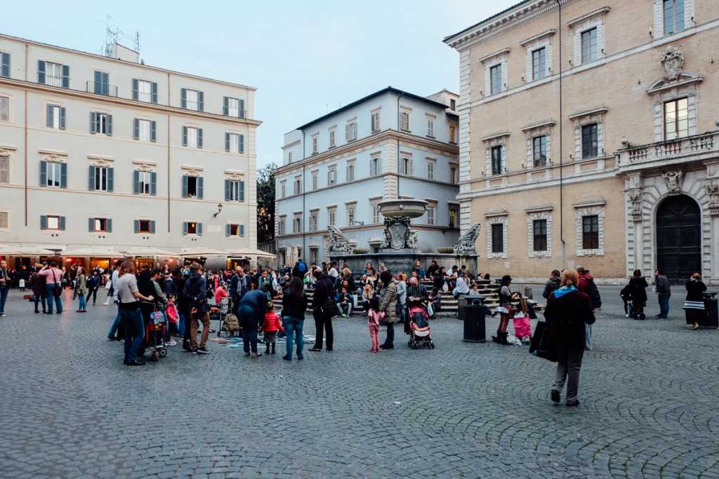 people in a public square in Trastevere