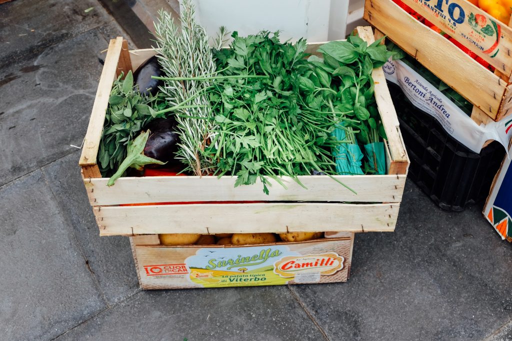 fresh herbs in a wooden crate in Rome