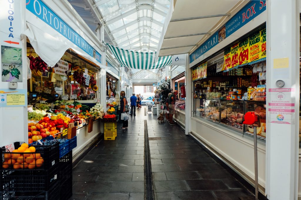 Looking down an aisle at Testaccio market with fresh food on either side