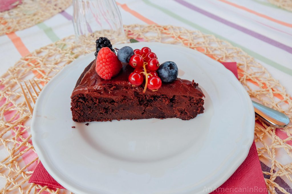 chocolate cake with berries on white plate