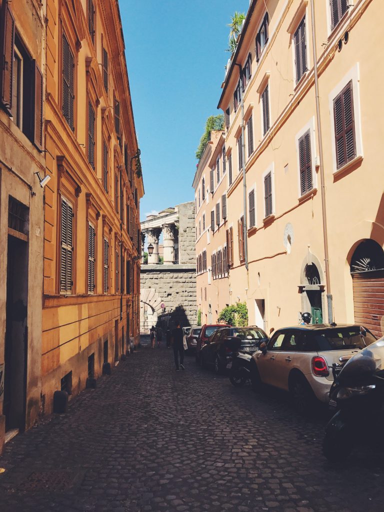 ruins visible at the end of a residential street in Monti Rome