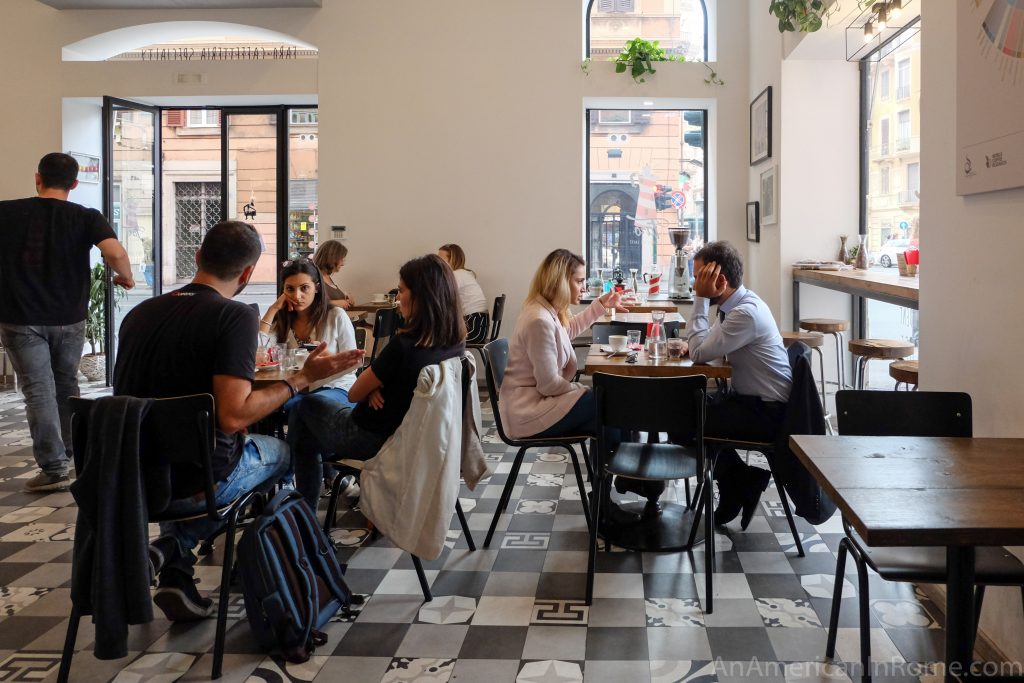 people sitting inside a Rome coffee bar