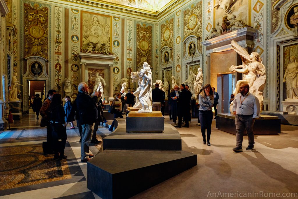 people walking around a statue in galleria borghese