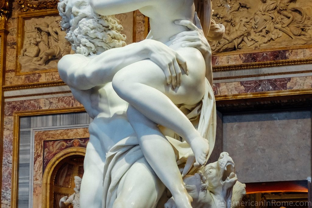 close up of bernini sculpture hands digging into thigh