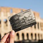 skip the line tickets for the colosseum with hand holding ticket in front of the rome monument
