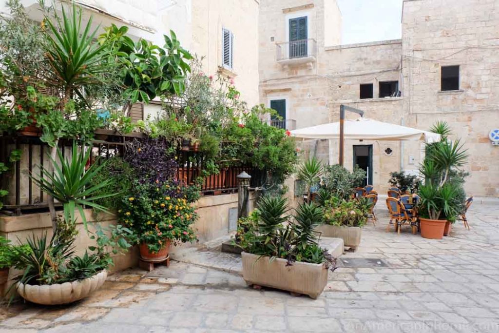 White washed piazza with plants in Polignano a Mare Puglia