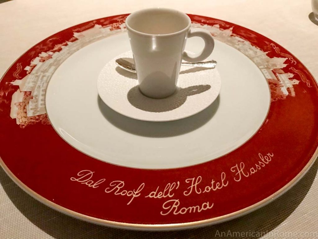 Coffee at Imago restaurant served on a red platter reading "dal roof dell'Hotel Hassler Roma"