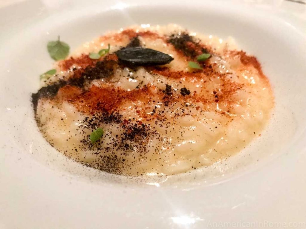 creamy risotto rice dusted with red and black spices served at Imago