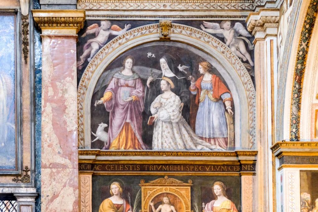 close up of fresco church in Milan with women and nun depicted in painting