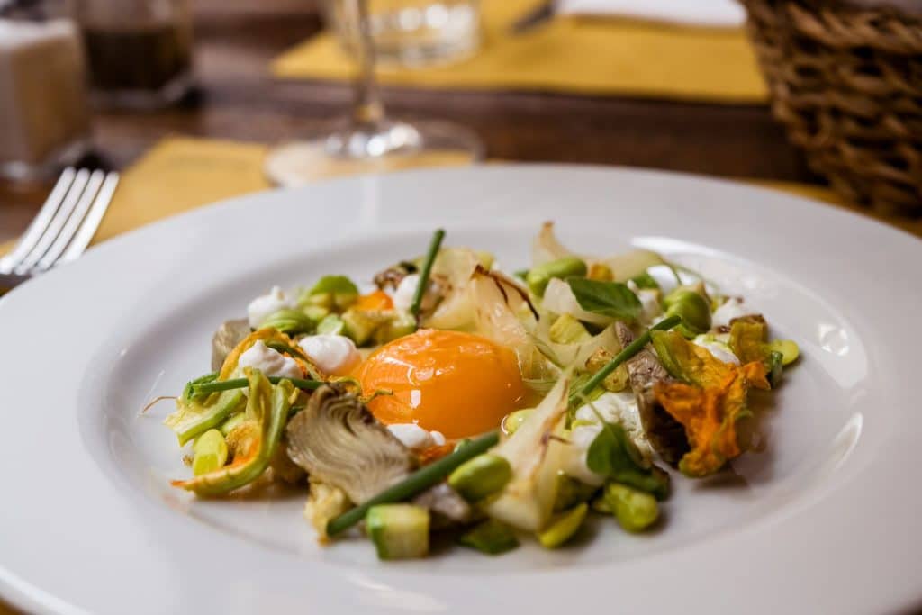 egg topped with braised vegetables at new restaurant Trattoria Pennestri in Rome