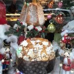 Pandoro and Panettone cakes in a window display are two the cakes that you should eat in Rome at Christmas