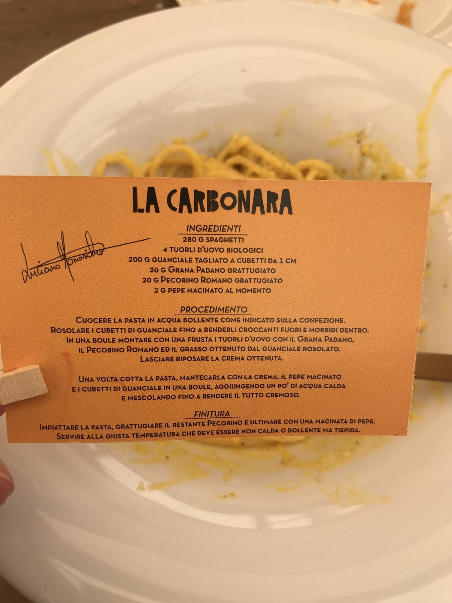 a small orange card with a carbonara recipe at Luciano near Campo de' fiori