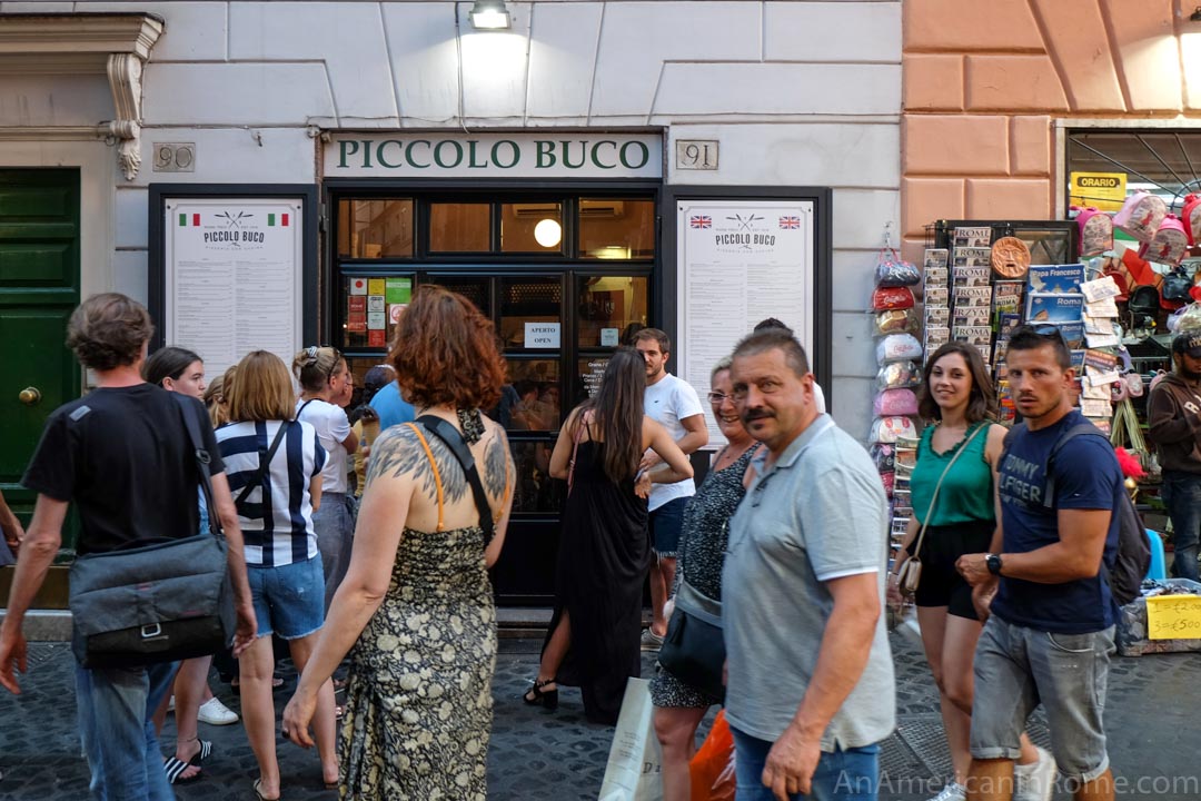 piccolo buco entrance behind crowds on the street