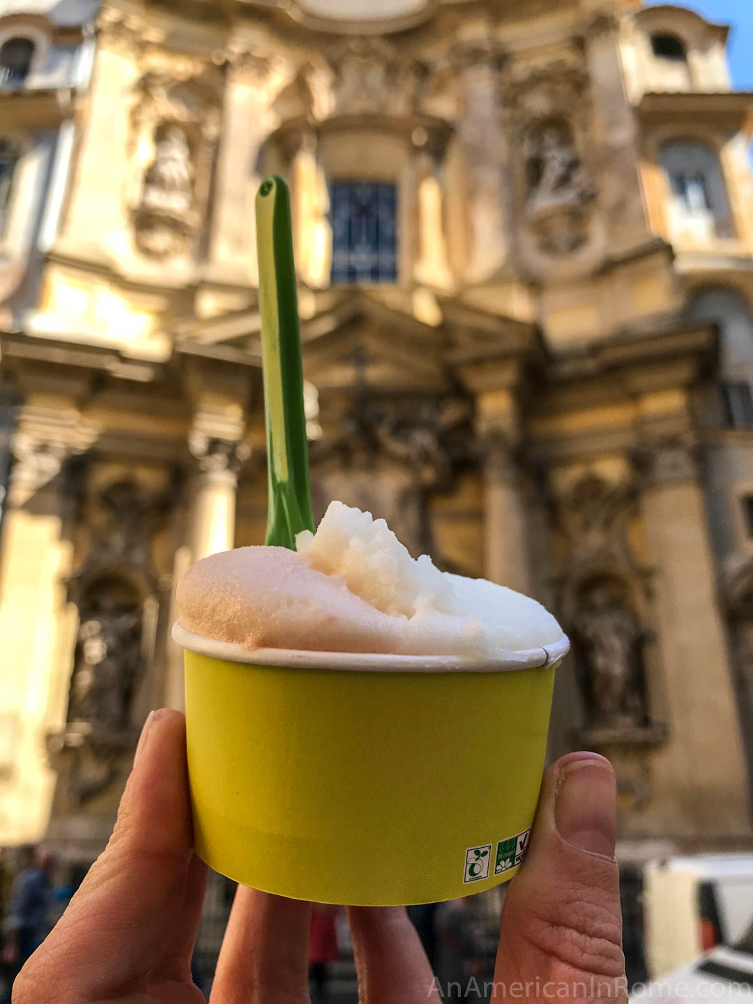 yellow cup of gelato with church behind