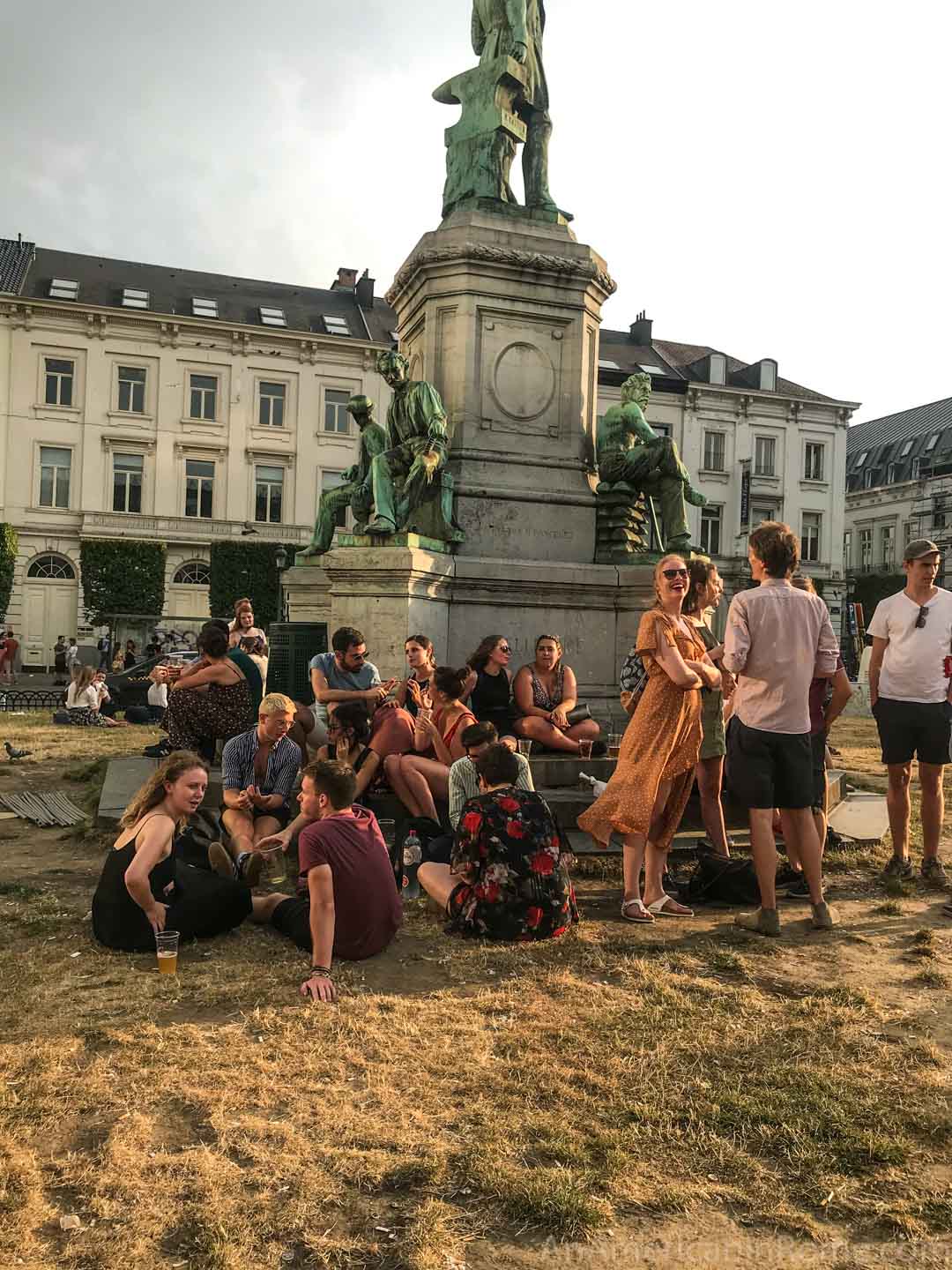 people around a statue at place du luxembourg brussels