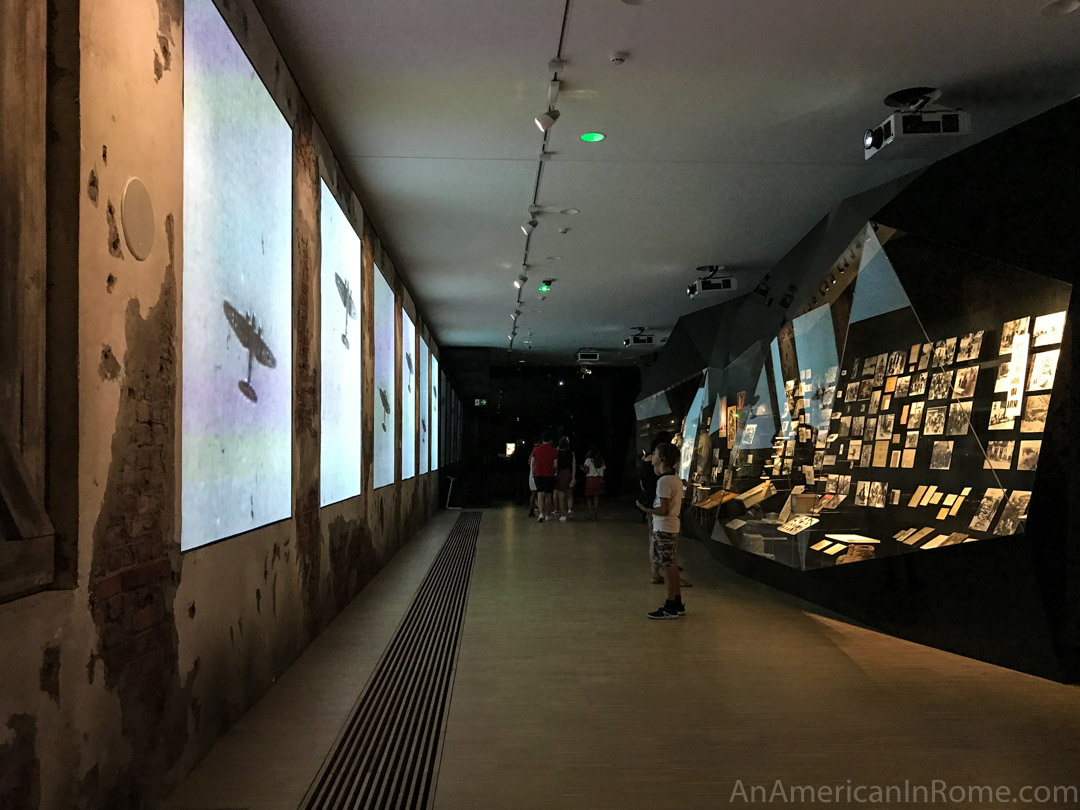 inside house of european history with video on one side and artefacts