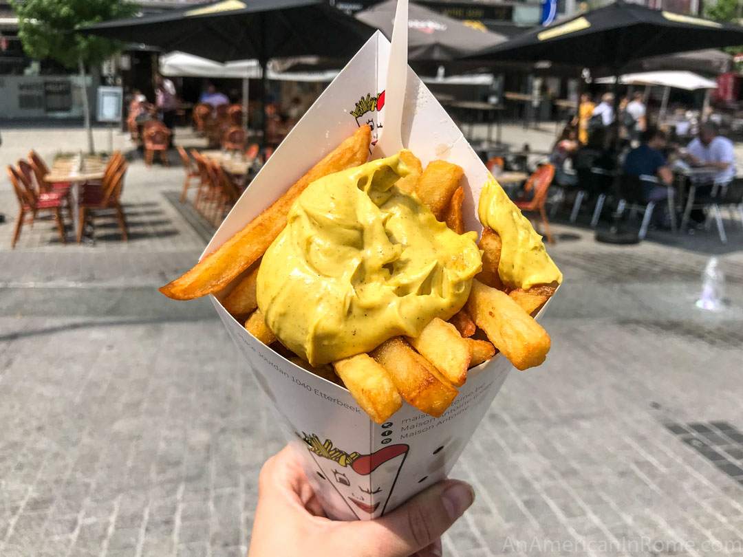 hand holding belgian fries