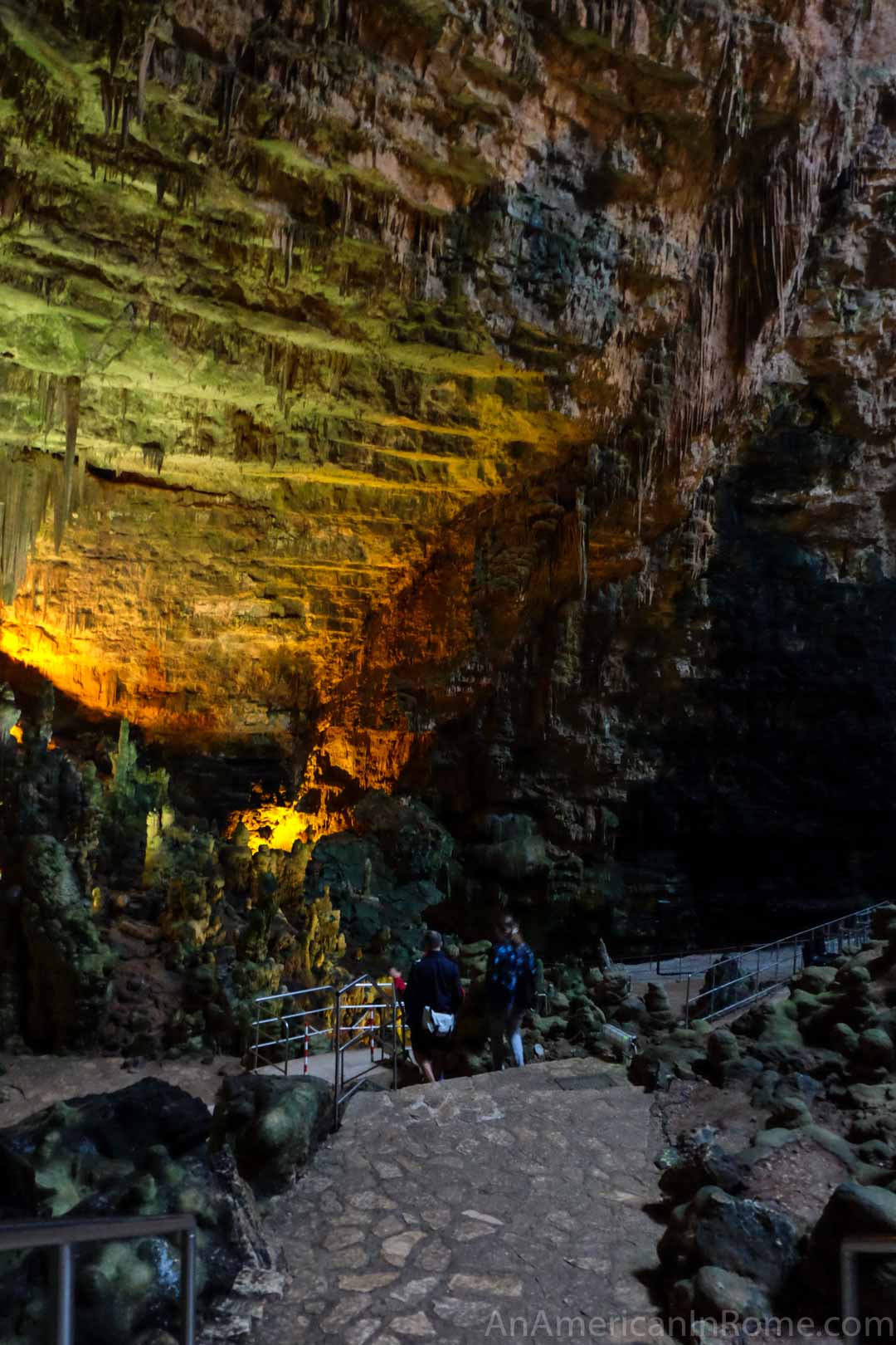 people stand at the bottom of cave