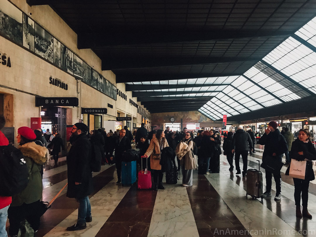 people waiting inside Florence train station