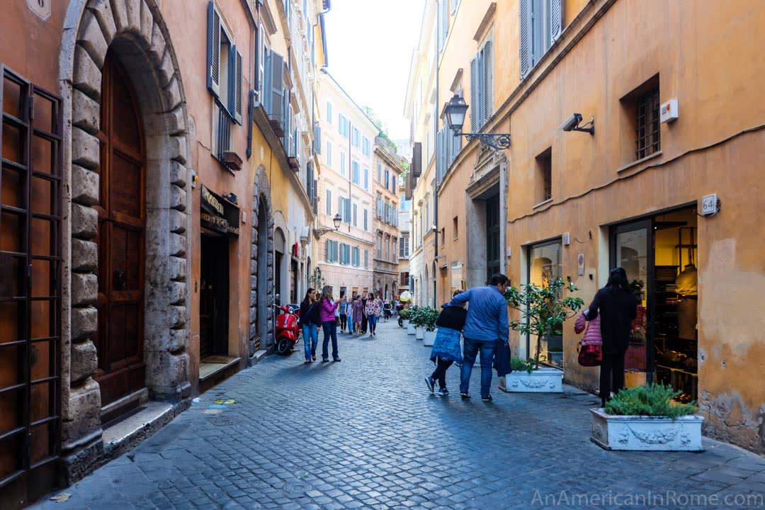 people look in a window on a Roman street