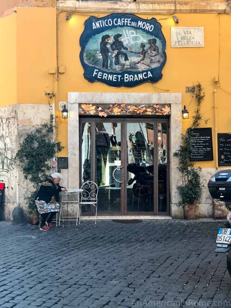 old woman sitting at cafe in Rome